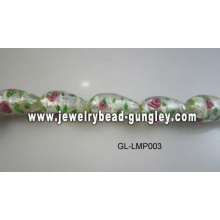 flower print and green leaf lampwork glass beads