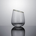 Slanted tumbler glass with gold rim