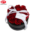 Boîte à fleurs rondes noire avec poignée de ruban