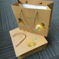 Golden foil shopping bags white kraft color paper