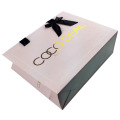 art paper bag with gold logo and ribbon