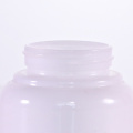 Round cream jars with white caps