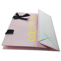 art paper bag with gold logo and ribbon