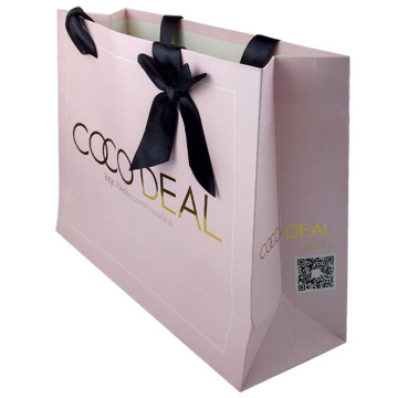 art paper bag with gold logo and ribbon