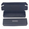 Black corrugated shipping box with white logo