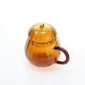 Taza de vidrio ámbar de calabaza con manija y tapa