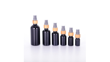 empty opaque black round glass bottle dropper pump for cosmetic packaging