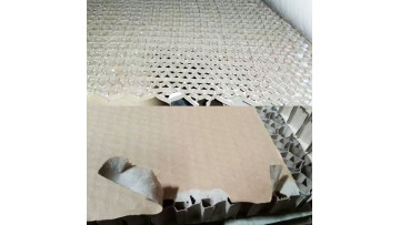 Honeycomb paperboard adhesive