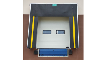 Warehouse loading dock with dock leveler 