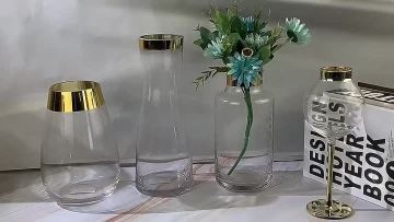 clear glass flower vase with gold rim