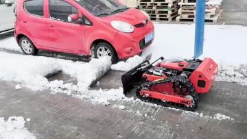 Track mower bulldozer shoveling snow